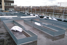 Planting beds with metal edgings on the roof