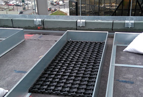 Planting beds with drainage mats on the roof