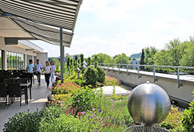 People on a roof garden with water feature and sitting area
