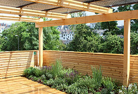 Roof garden with wooden deck and PV pergola