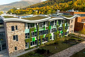 Building with wavelike green roofs and vertical greening